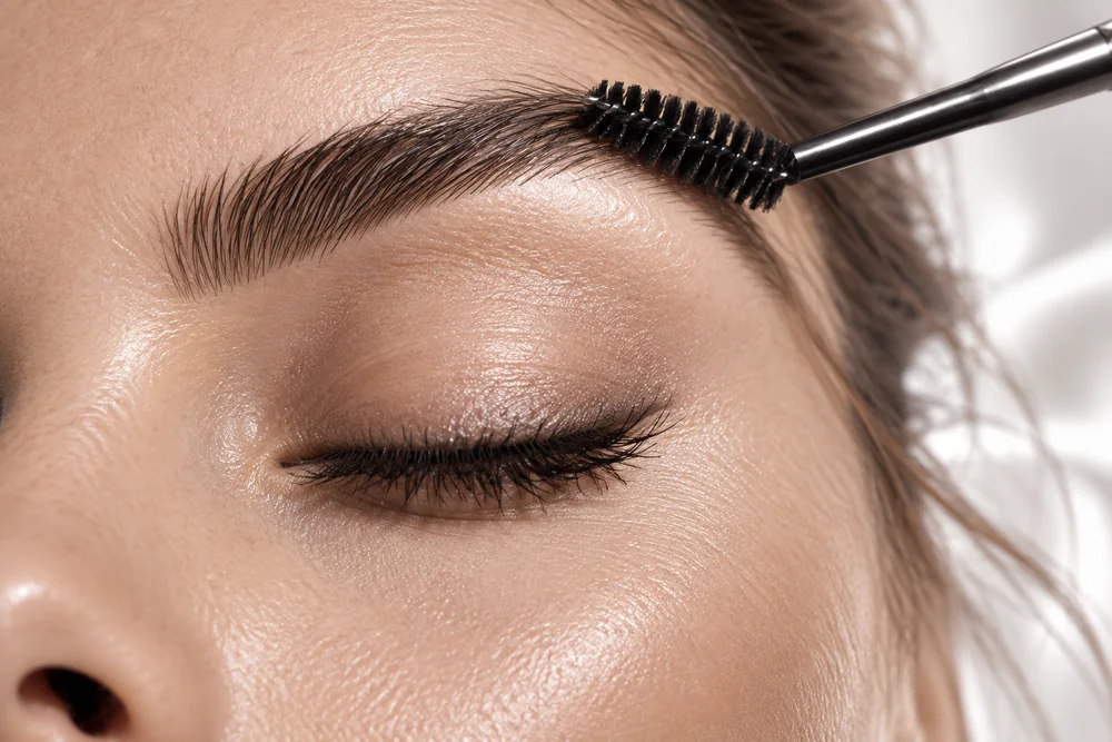 Eyebrow brushed into shape with a spoolie; concept photography